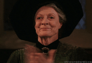 Dame Maggie Smith applauds and smiles, dressed as Professor McGonagall from Harry Potter