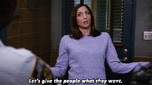 Chelsea Peretti from Brooklyn 99 shrugs, with a caption that reads "Let's give the people what they want."