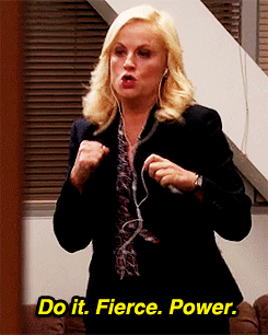 Leslie Knope air punches with headphones on while saying, "Do It. Fierce. Power."