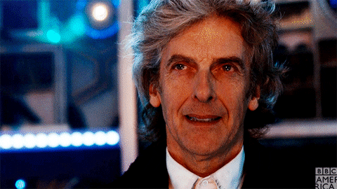 Peter Capaldi as the Doctor says, "Be kind" with dramatic lighting.